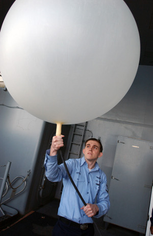 US_Navy_040506-N-2788L-037_Aerographers_Mate_3rd_Class_Arthur_Griffin_of_Fort_Lauderdale_Fla._fills_a_weather_balloon_with_helium_gas_before_releasing_it_from_the_fantail_of_USS_Ronald_Reagan_CVN_76_300